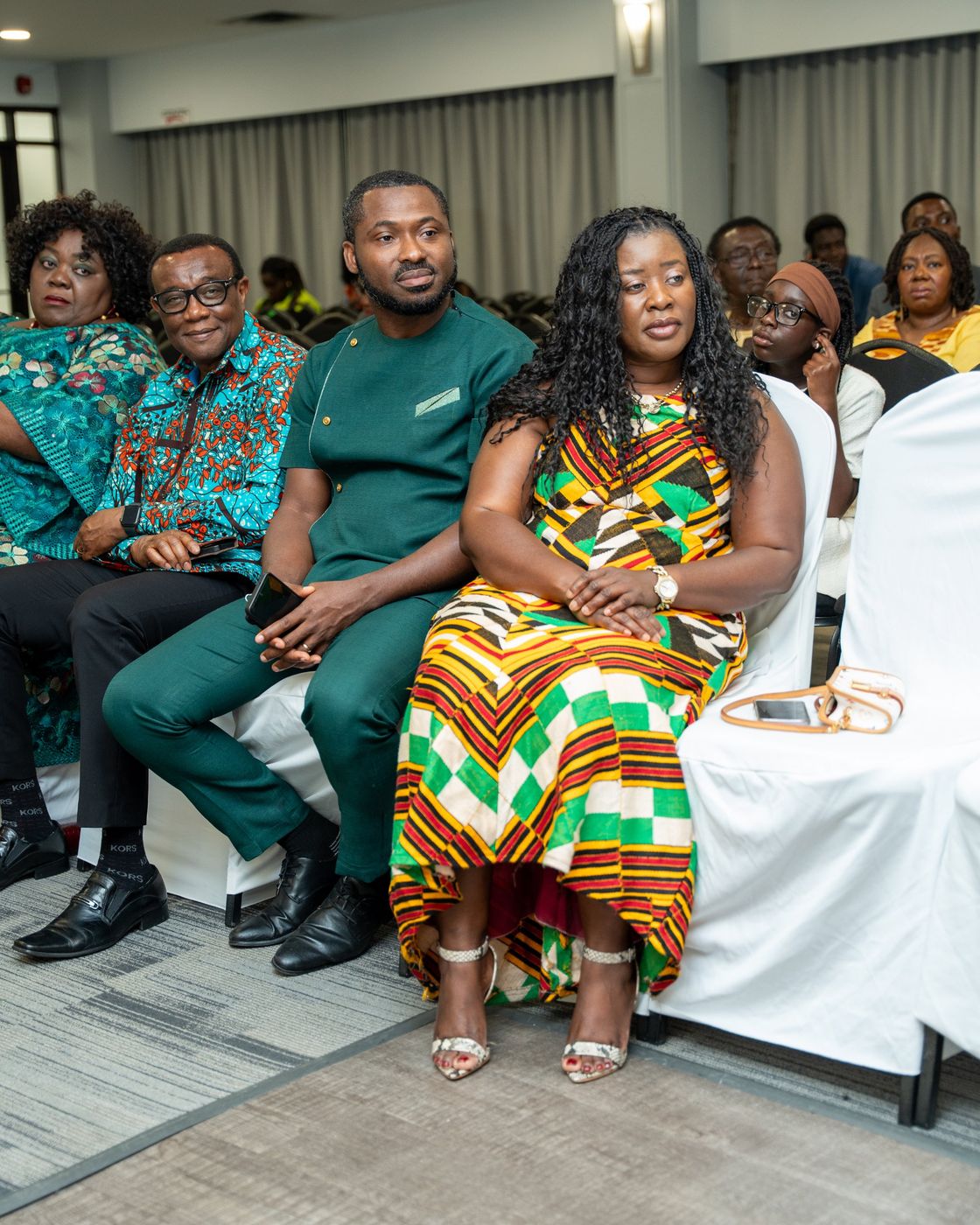 Guests in kente and African print seated in the front row