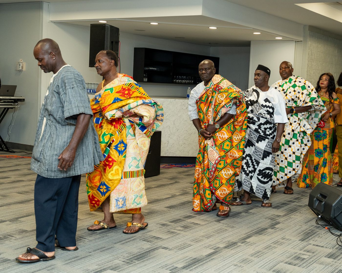 Elders in kente cloth walking in procession