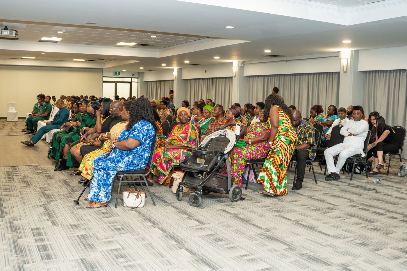 A full room of guests in African print