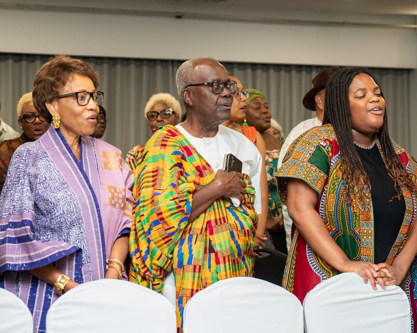 Guests in kente singing during the program