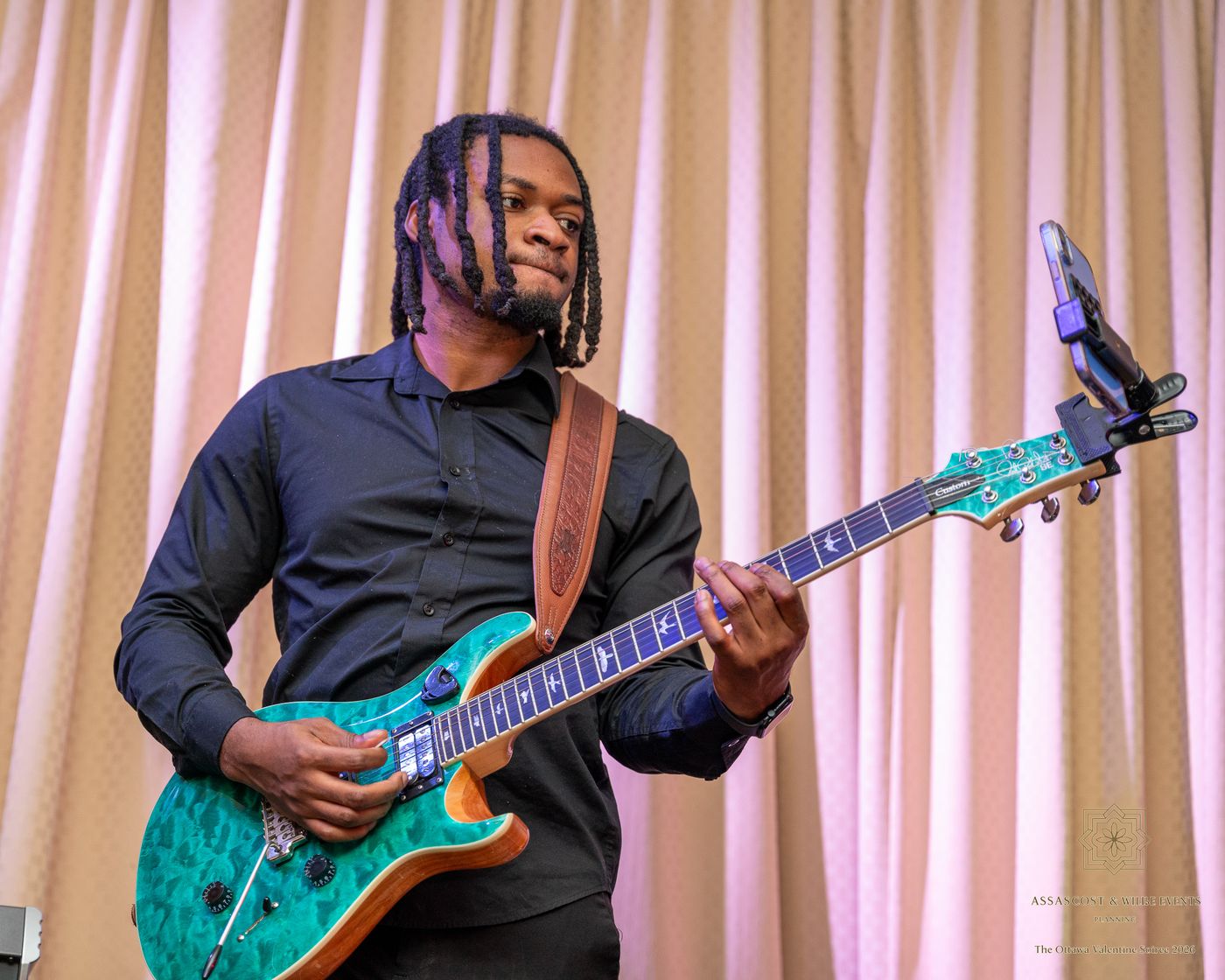 The band's guitarist playing a green electric guitar