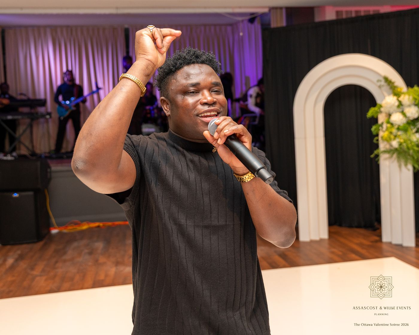 The singer performs on the dance floor with the live band behind him